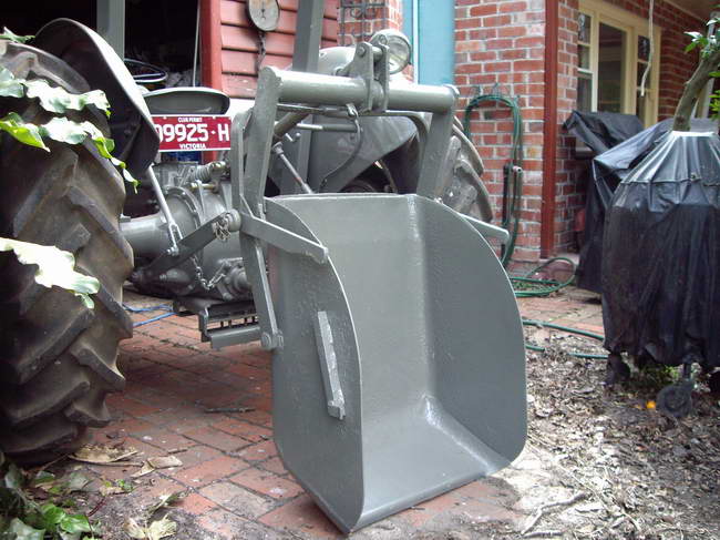 Rearward dumping position prior to reset